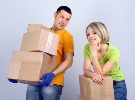 Packed moving boxes and furniture ready for transport in Shirley